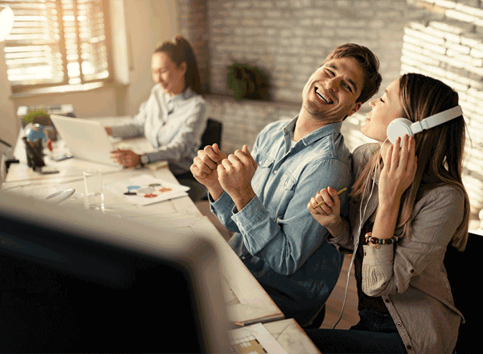 Um homem e uma mulher sentados em uma mesa rindo